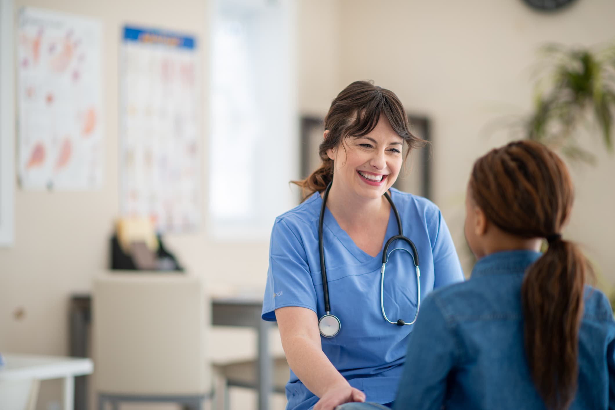 Compassionate nurse speaking with a patient during a primary care appointment at a medical clinic