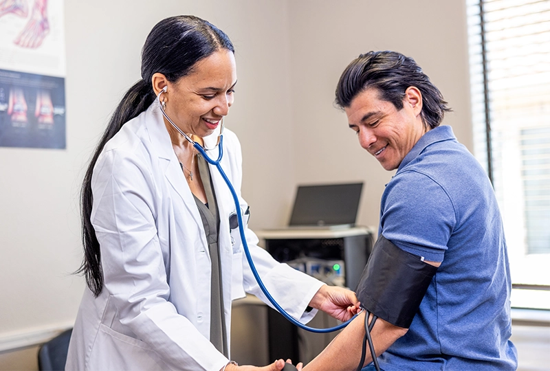 Provider checking blood pressure