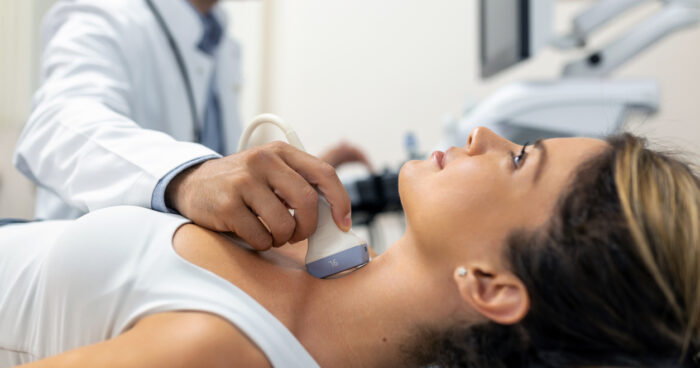 Patient receiving a thyroid ultrasound examination during an evaluation