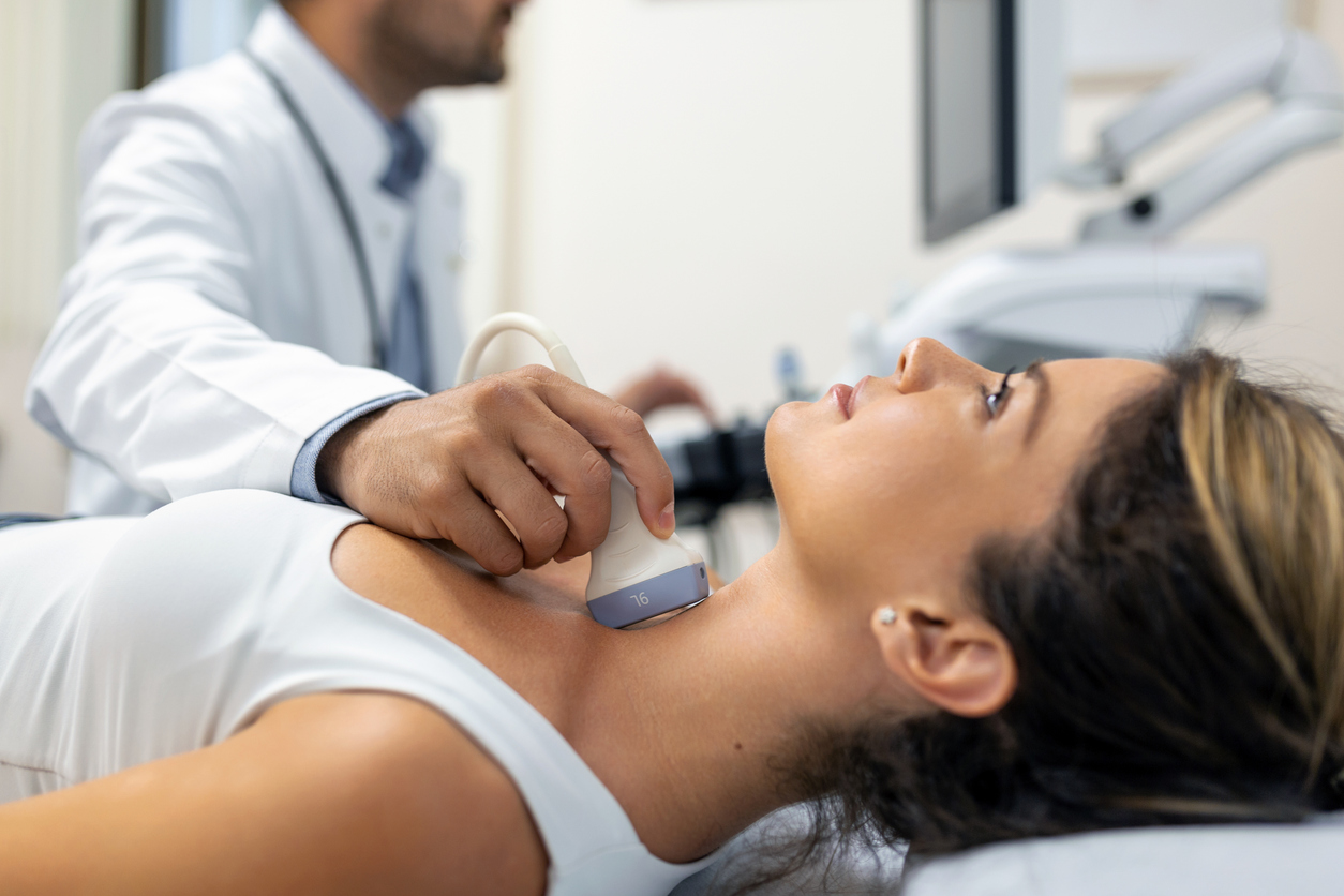Patient receiving a thyroid ultrasound examination during an evaluation